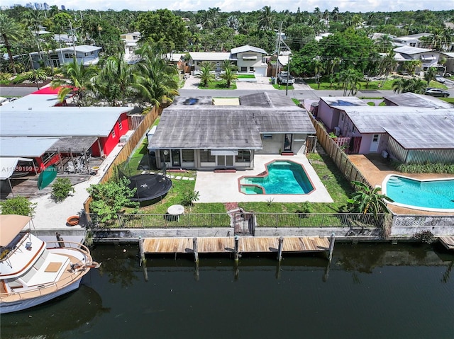 exterior space with a water view, a fenced in pool, and a patio area