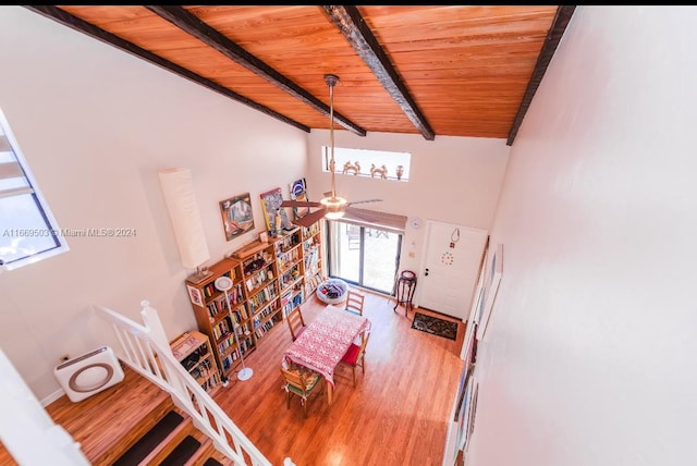 interior space featuring ceiling fan, wooden ceiling, wood-type flooring, and beam ceiling