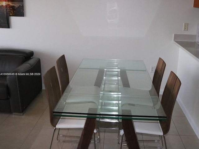 dining area with light tile patterned flooring