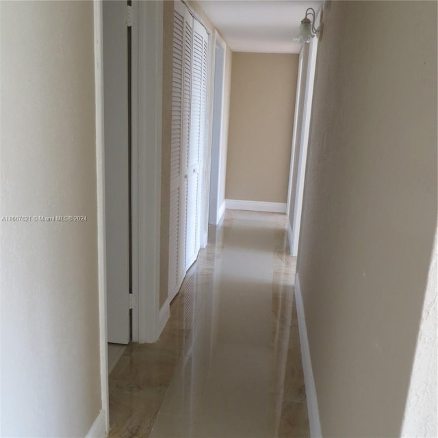 hallway featuring baseboards