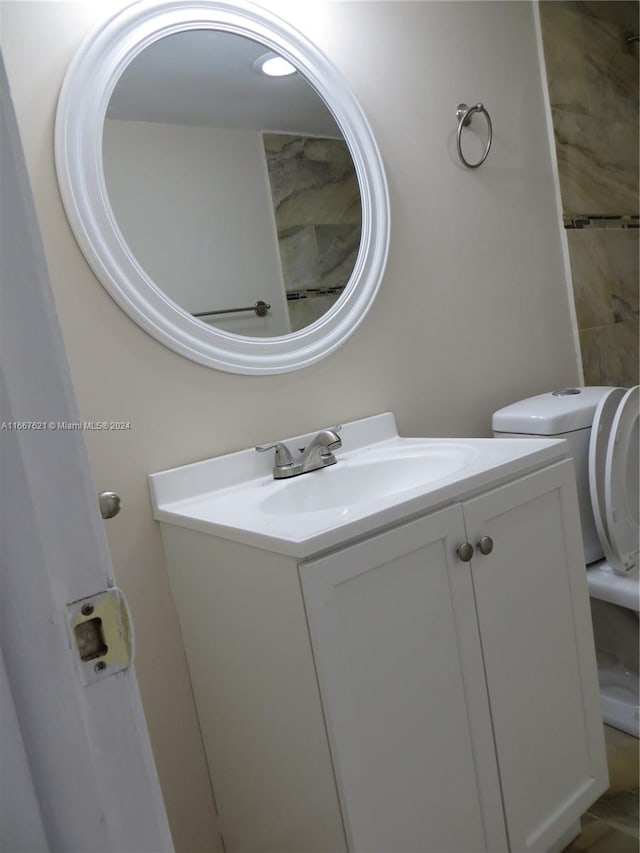 bathroom featuring vanity and toilet