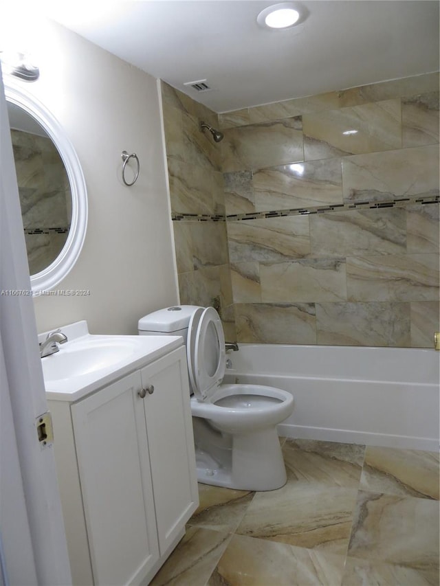 bathroom with vanity, visible vents, toilet, and shower / washtub combination