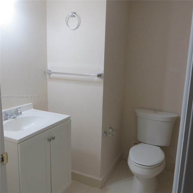 bathroom with vanity, toilet, and tile patterned floors