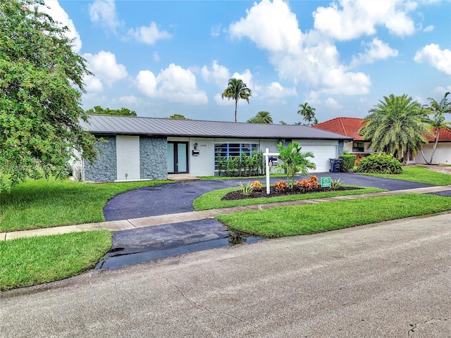 single story home with a garage and a front yard