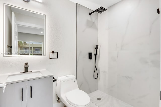 bathroom featuring walk in shower, vanity, and toilet