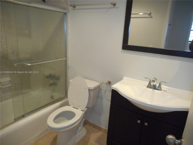 full bathroom with enclosed tub / shower combo, vanity, toilet, and tile patterned floors