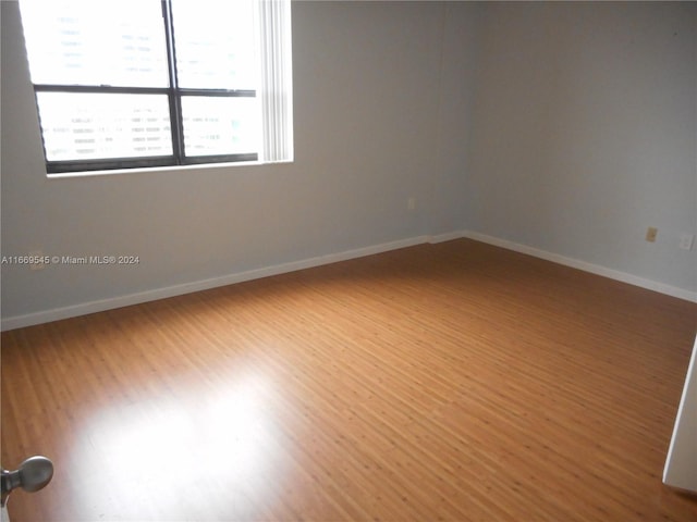 spare room with wood-type flooring