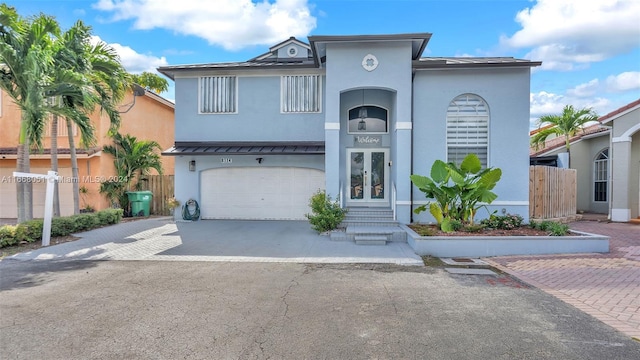 view of front of property featuring a garage and french doors