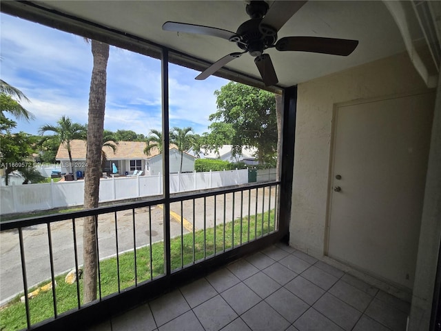 unfurnished sunroom with ceiling fan and a healthy amount of sunlight