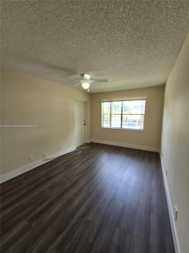 unfurnished room with ceiling fan, dark hardwood / wood-style floors, and a textured ceiling