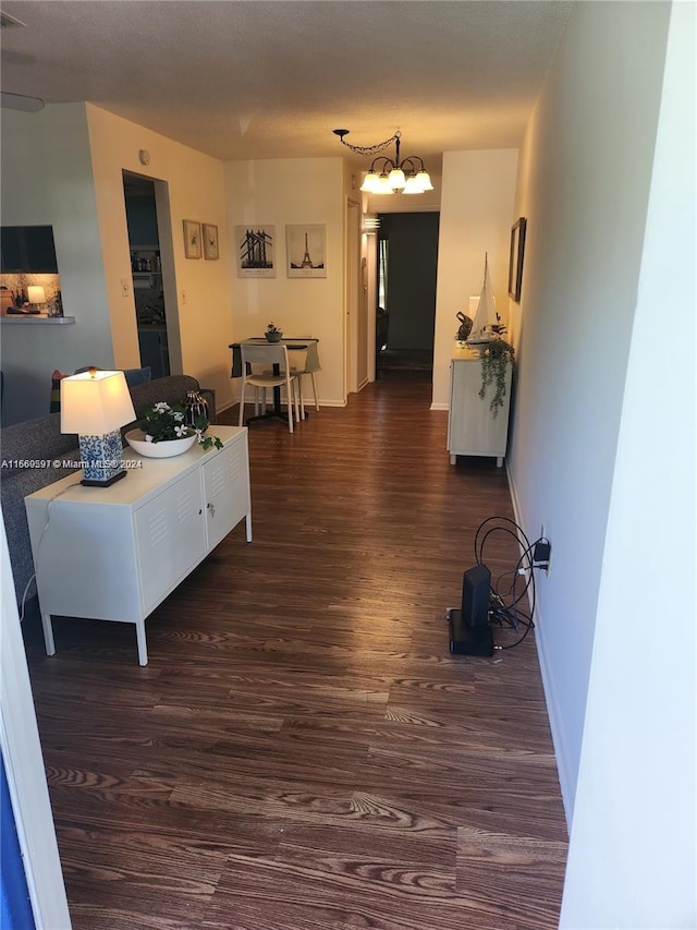 living room featuring a chandelier and dark hardwood / wood-style flooring