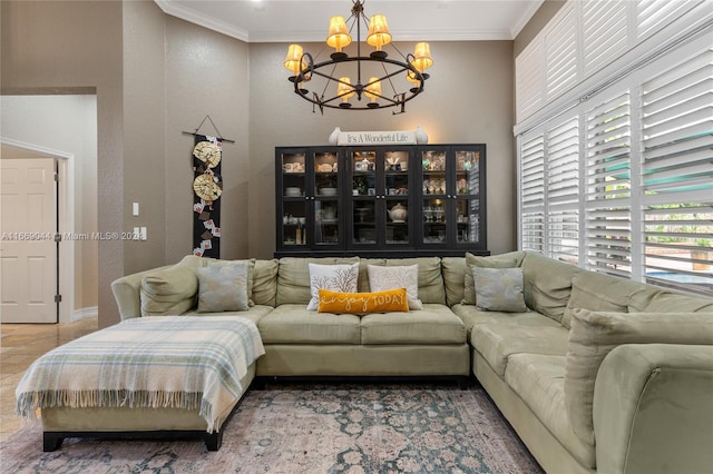 living room with ornamental molding and a chandelier