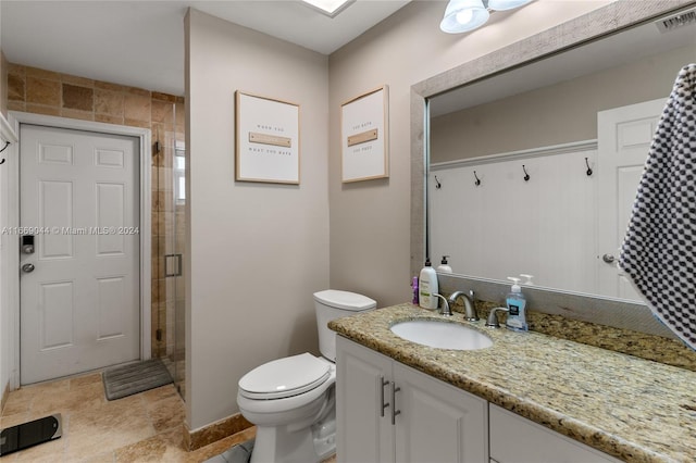 bathroom with vanity, toilet, and an enclosed shower