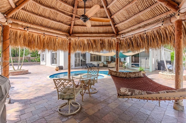 view of swimming pool featuring ceiling fan, a gazebo, and a patio