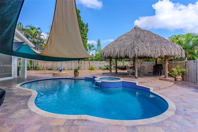 view of swimming pool with a patio, an in ground hot tub, and a gazebo