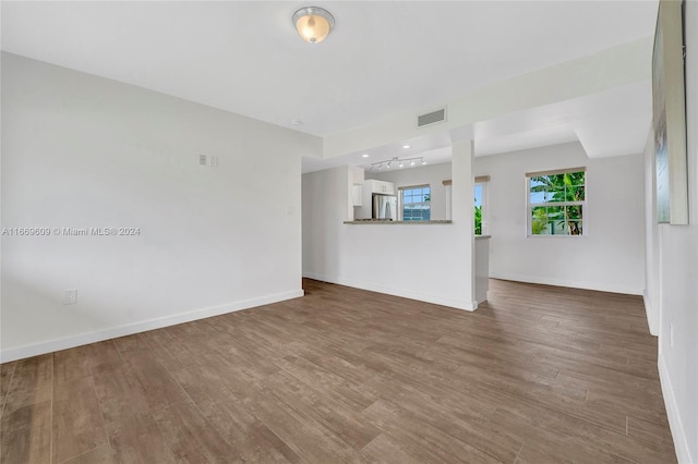 unfurnished living room with wood-type flooring