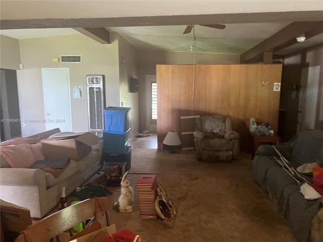 living room with lofted ceiling with beams, ceiling fan, and carpet floors