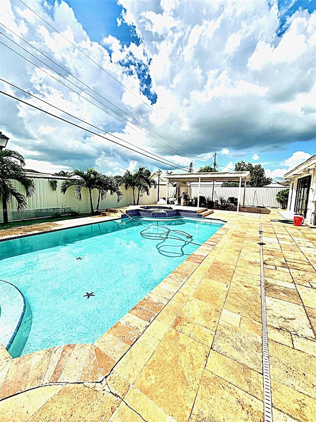 view of swimming pool with a patio