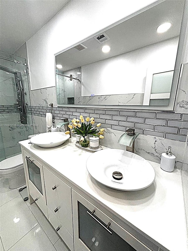 bathroom with vanity, walk in shower, tile walls, toilet, and decorative backsplash