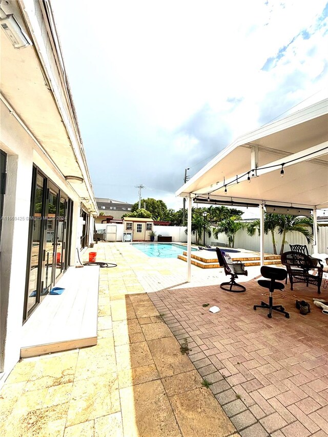 view of swimming pool with a patio area