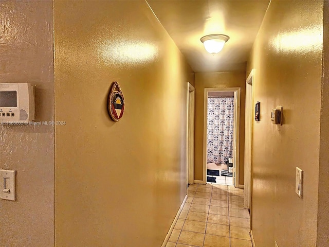 hall with light tile patterned floors