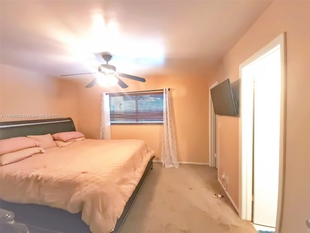 bedroom with ceiling fan and light carpet