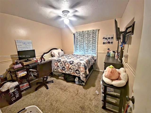 carpeted bedroom with ceiling fan and a textured ceiling