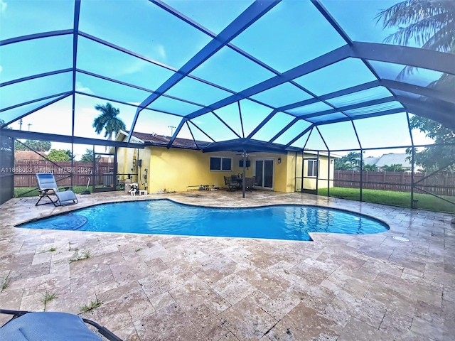 view of pool featuring ceiling fan, a patio area, and a lanai