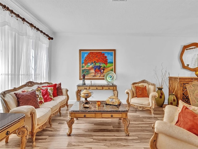 living area featuring ornamental molding and light hardwood / wood-style floors