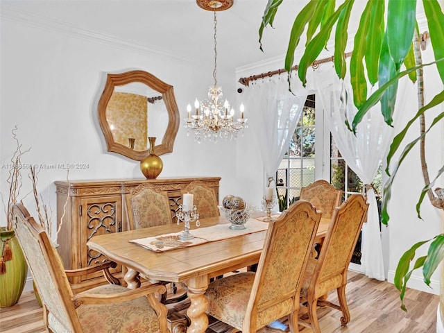 dining room featuring light hardwood / wood-style floors, ornamental molding, and a chandelier