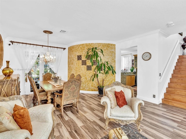 interior space with crown molding, a chandelier, and light wood-type flooring