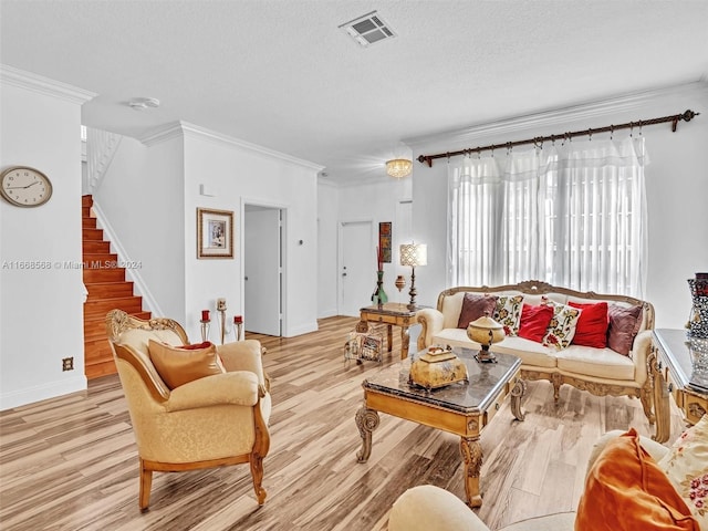 living room with crown molding, a textured ceiling, and light wood-type flooring