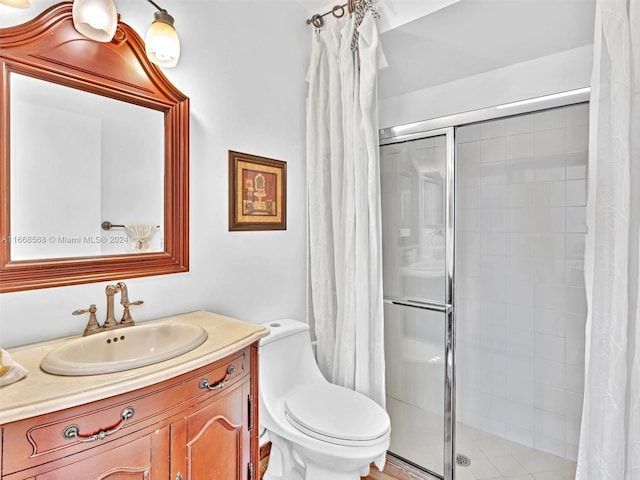 bathroom with vanity, toilet, and curtained shower