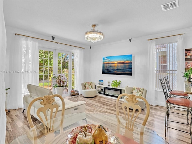 living room with a notable chandelier and light wood-type flooring