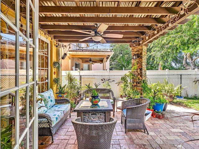 view of patio / terrace with an outdoor living space with a fire pit, a pergola, and ceiling fan