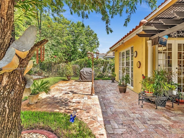 view of patio featuring french doors and a pergola