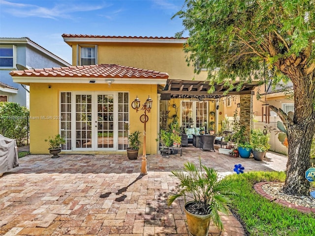 rear view of property with french doors and a patio area