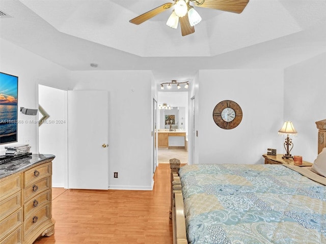 bedroom featuring ceiling fan, ensuite bathroom, and light hardwood / wood-style floors