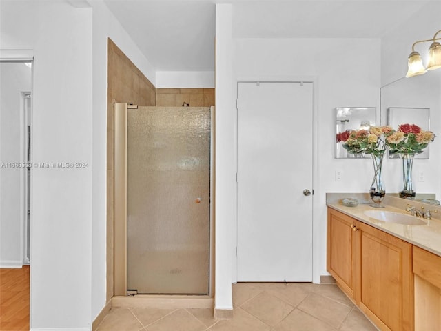 bathroom featuring vanity, walk in shower, and tile patterned flooring