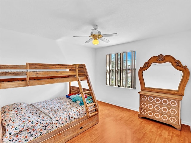 bedroom with wood-type flooring and ceiling fan