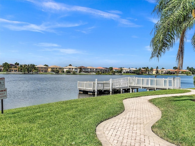 dock area featuring a water view and a lawn