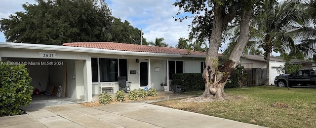 single story home with a front lawn and a carport