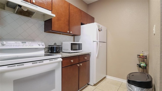 kitchen featuring white appliances, light tile patterned floors, and backsplash