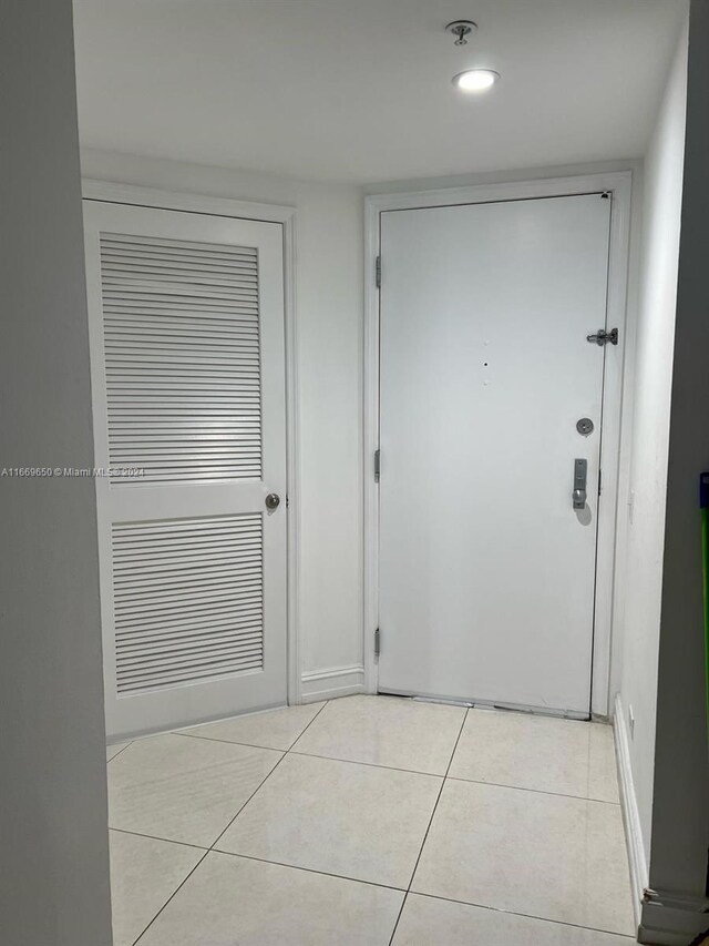701 Brickell Key Blvd Unit 1108, Miami, FL 33131 - doorway to outside with light tile patterned flooring and recessed lighting
