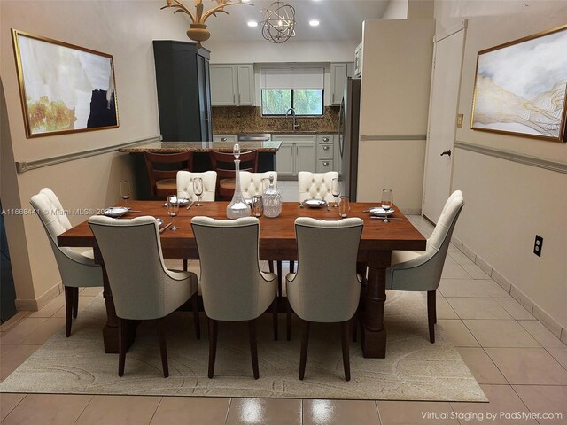 kitchen featuring an inviting chandelier, light stone counters, light tile patterned floors, and decorative light fixtures