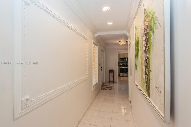 corridor with crown molding, light tile patterned floors, recessed lighting, and baseboards