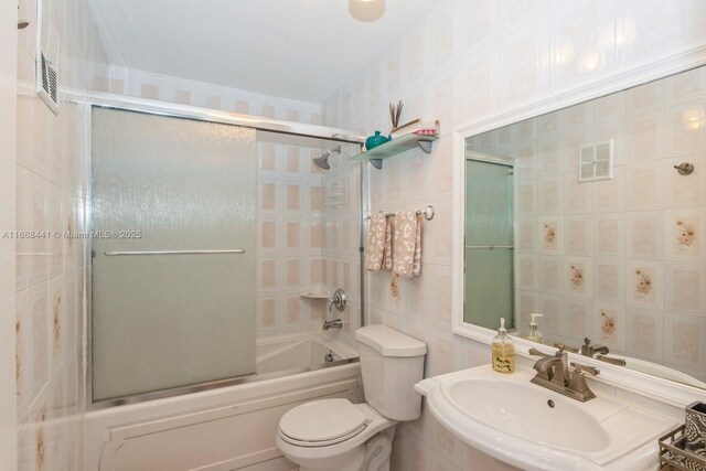 bathroom with tile walls, a shower with door, and vanity