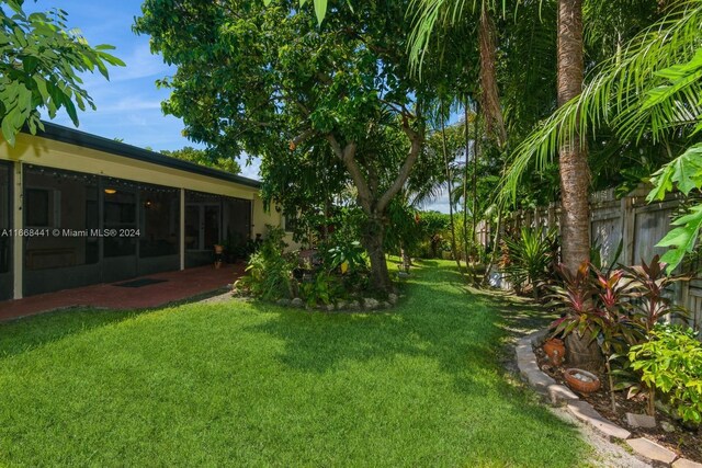 view of yard featuring a sunroom