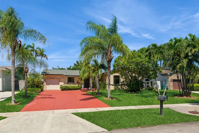 view of front of home with a garage and a front lawn