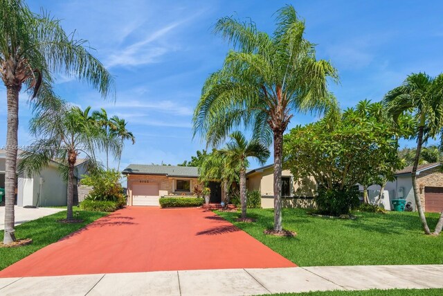 view of front of property with a garage and a front lawn